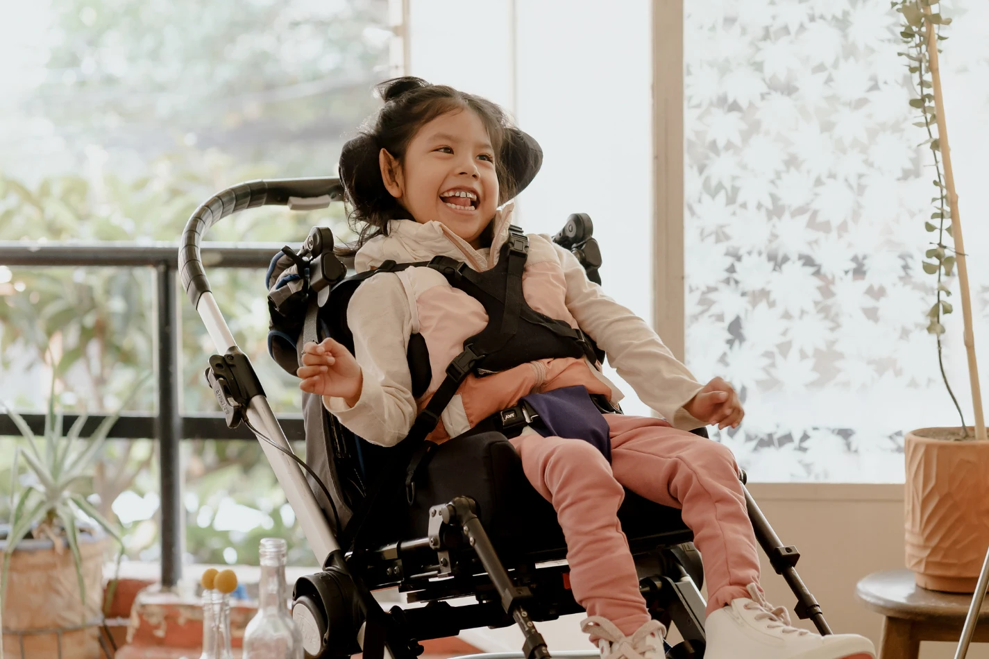 Disabled girl in wheelchair smiling