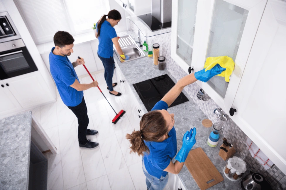 Cleaners cleaning kitchen